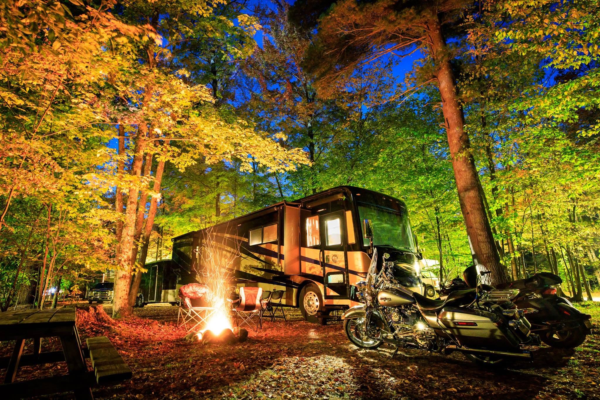 Campfire and bikes at an autumn campsite